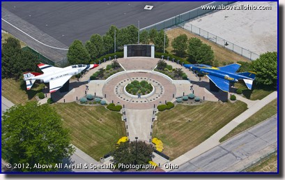 A low and close helicopter aerial view of the Marjorie Rosenbaum Plaza at Burke Lakefront Airport in downtown Cleveland, Ohio.