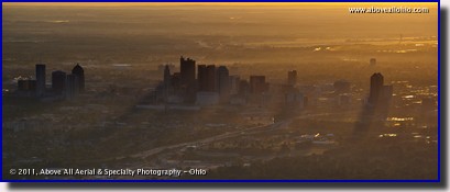The sun rises over Columbus, OH, in this aerial panoramic view from the southwest side of the city.