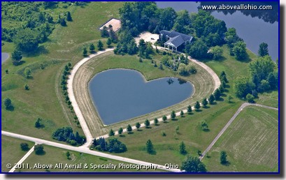 An aerial view of a unique heart shaped pond in front of a residential property; near Cleveland, Ohio.