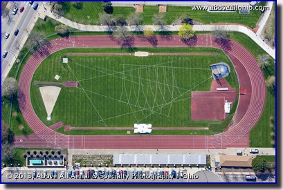 A steep oblique aerial view of a track and associated field event markings at the University of Akron (Ohio).