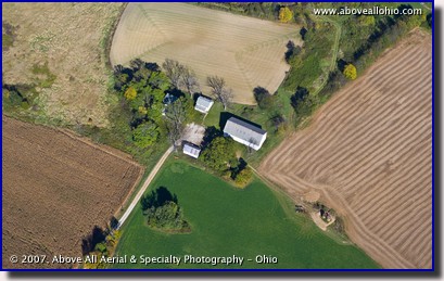 An aerial photo of a small farm house and surrounding land in the early fall. Medina County, Ohio