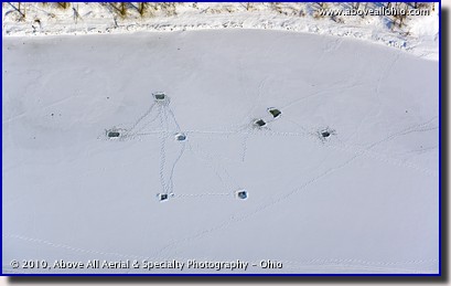 Aerial view of ice fishing holes drilled into a frozen lake near Pittsburgh, Pennsylvania