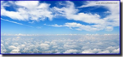 An airborne very high resolution panoramic view of the blue sky between two layers of clouds