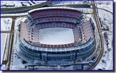 An aerial view looking into Cleveland Browns Stadium, full of snow and ice; downtown Cleveland, Ohio
