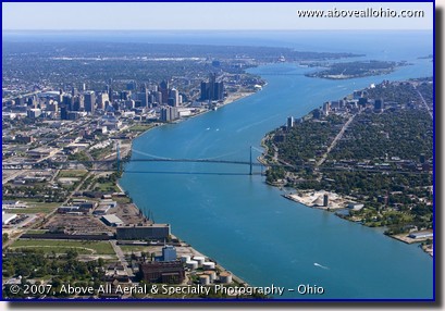 Aerial photograph of downtown Detroit, Michigan, the Ambassador Bridge, the Detroit River, Belle Isle, and Windsor, Ontario, Canada