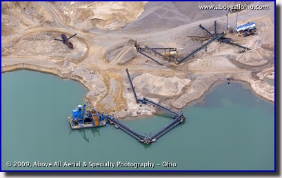 Aerial photo of a quarry, lake, and conveyeying equipment