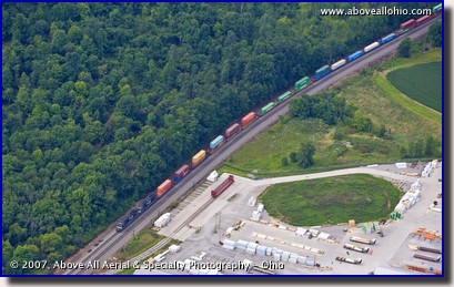 Aerial view of a lumber yard and a very wooded area separated by train tracks in Pennsylvania